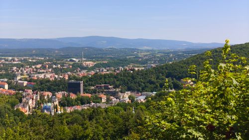 Free Aerial view of Karlovy Vary, Czech Republic surrounded by lush greenery. Stock Photo