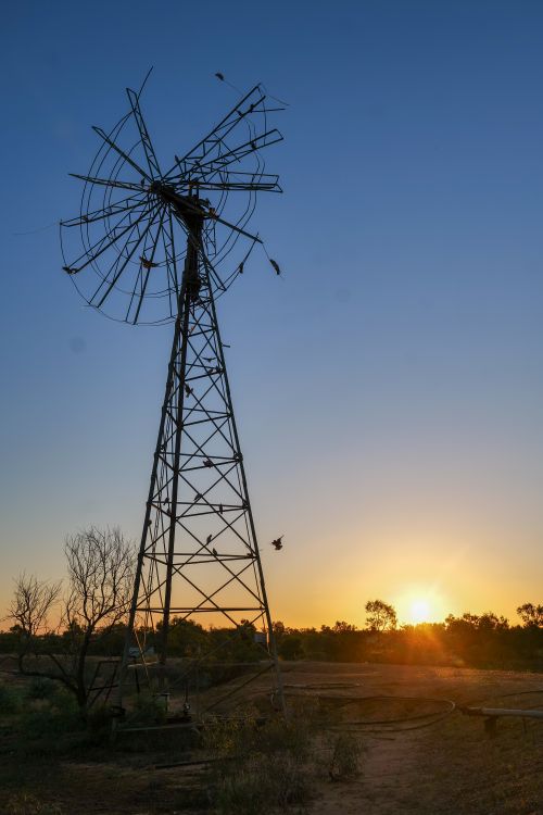 Free Captivating sunset over a windmill in Witjira, South Australia. Stock Photo