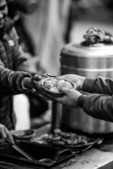 A candid moment capturing the exchange of street food in Lalitpur, Nepal.