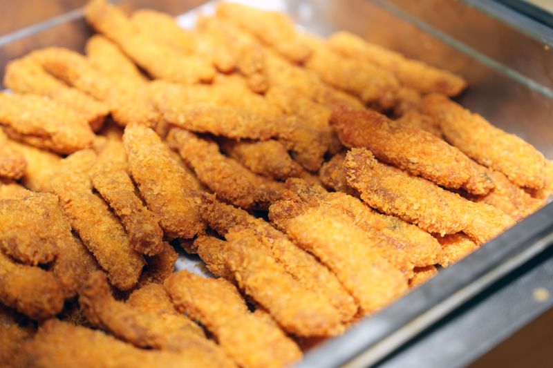 Homemade fish fingers with peas