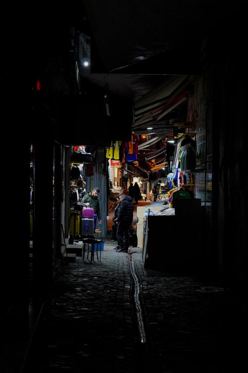 Free Explore the lively yet calm atmosphere of a dimly lit market street in Istanbul at night. Stock Photo