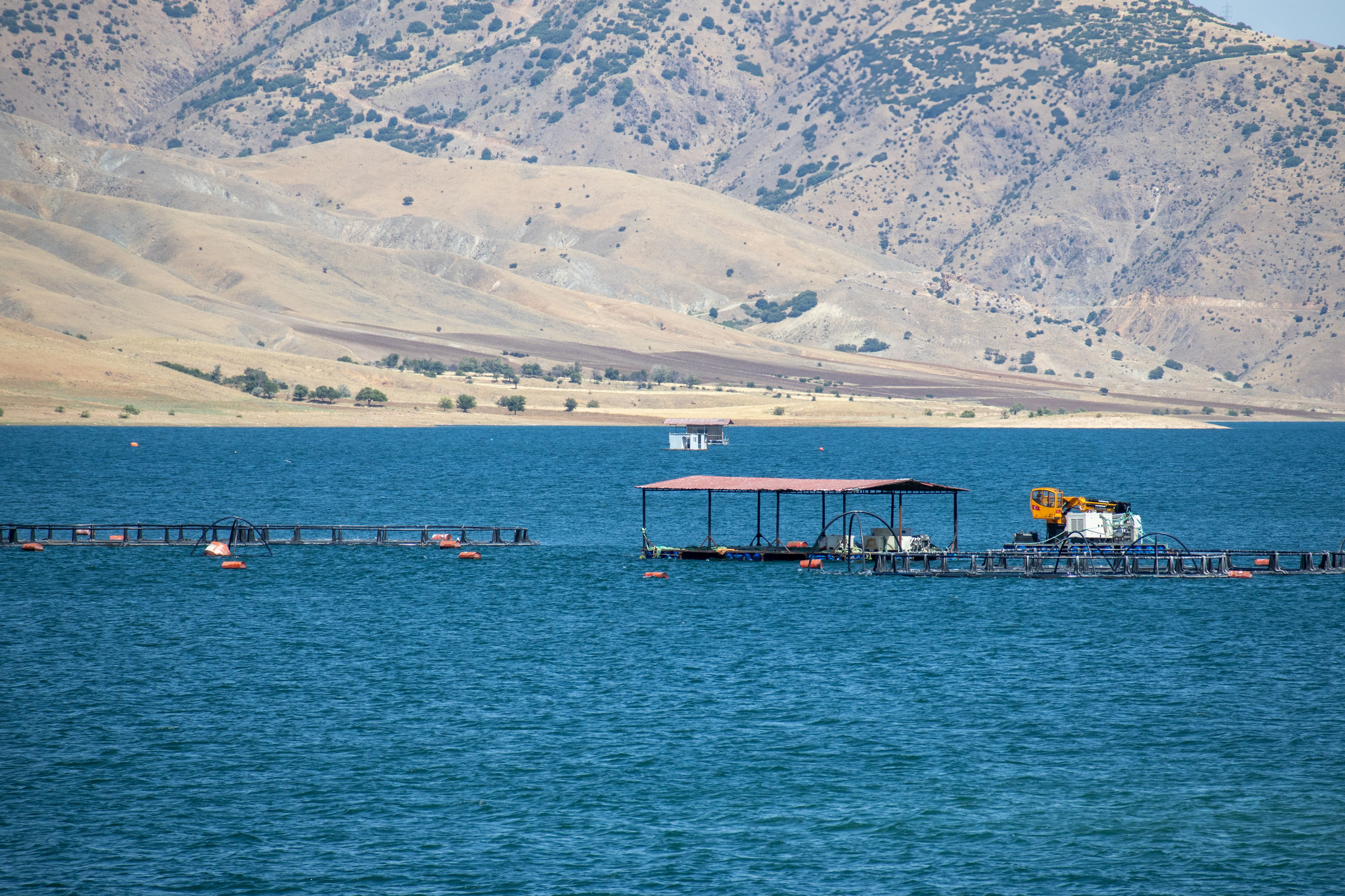 A picturesque view of Keban Reservoir with fish farms in Pertek, Tunceli, Türkiye.
