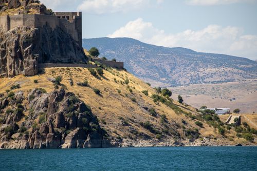 Free Scenic view of Pertek Castle standing majestically over Keban Lake, showcasing historical architecture amidst stunning natural landscapes. Stock Photo