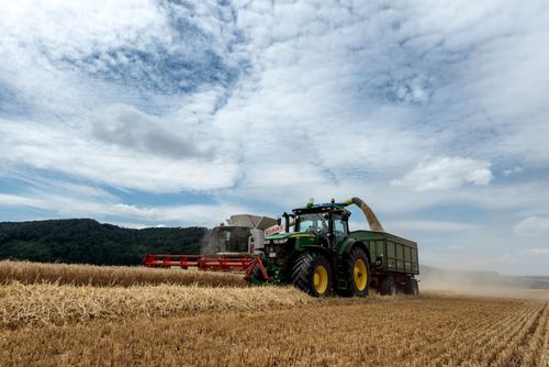Free Combine harvester working in a wheat field under a clear sky in Höxter, Germany. Stock Photo