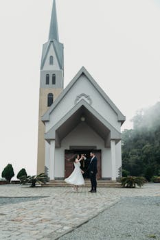 Bride and groom dancing outside a beautiful church on their wedding day.