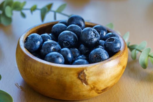 A close-up of juicy blueberries in a rustic wooden bowl, perfect for healthy eating.