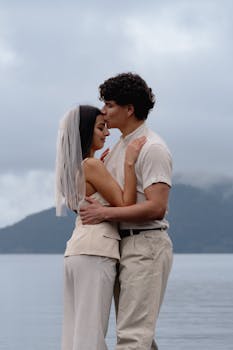 Newlywed couple embracing by a serene lake in Bariloche, capturing love and tranquility.
