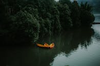 Serene Lake with Yellow Boats and Lush Forest