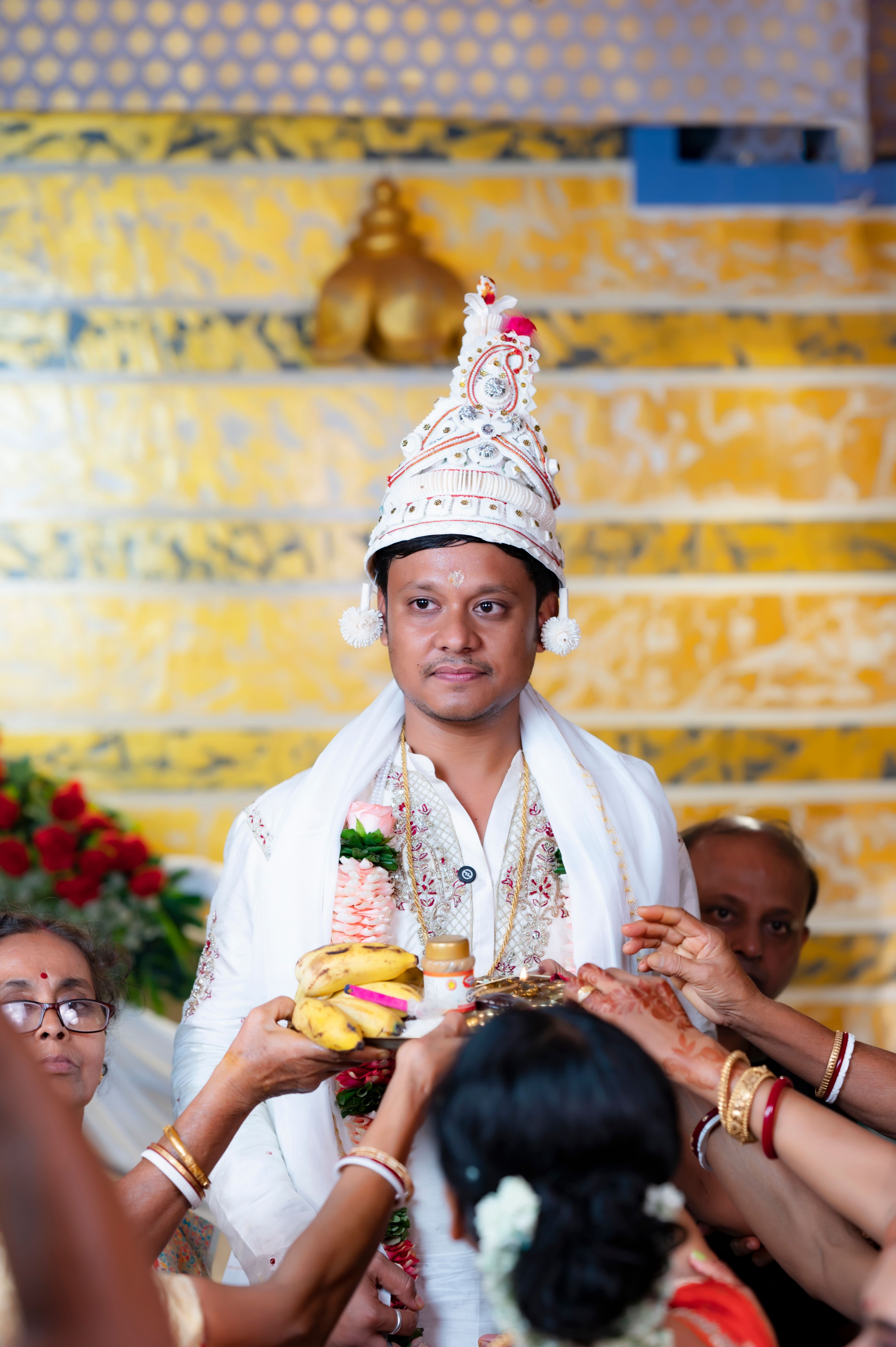 Groom surrounded by family during a wedding ceremony