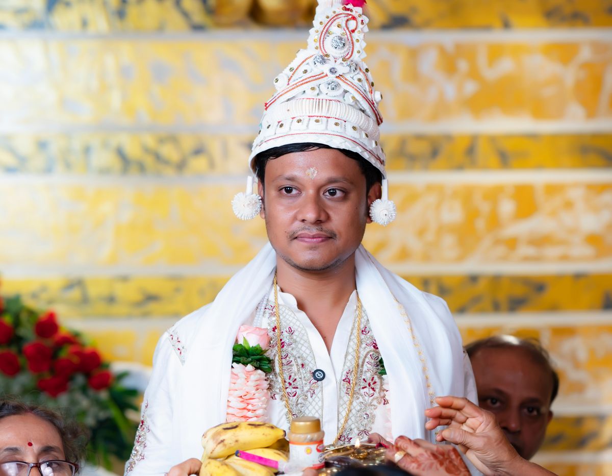 Groom surrounded by family during a wedding ceremony