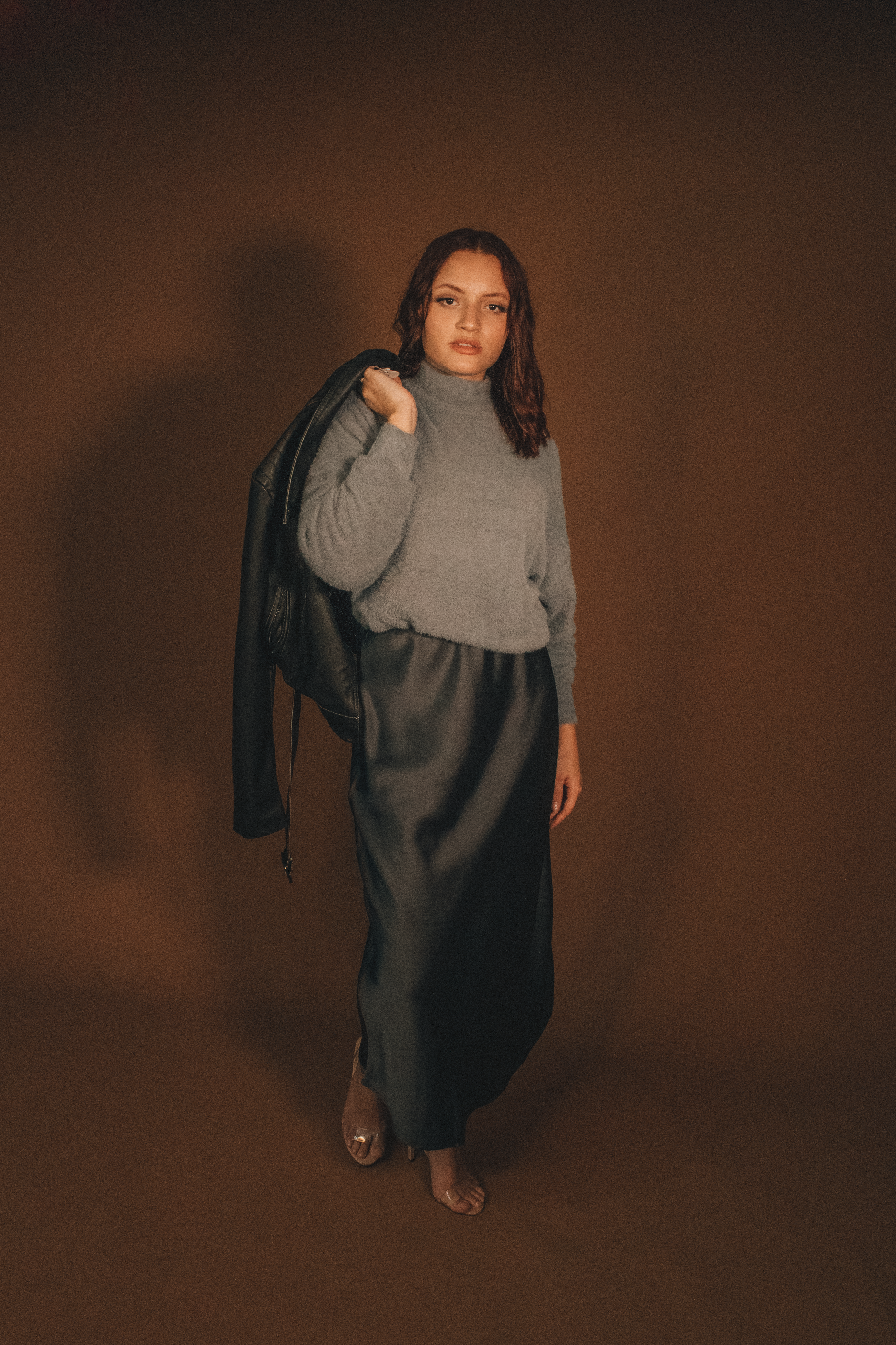 Woman in a satin midi skirt with a cashmere turtleneck