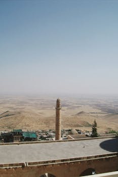 Stunning view of the minaret and rolling dry hills in Mardin, Turkey.