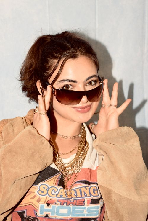 Free Stylish young adult wearing sunglasses and layers of jewelry, exuding confidence in Long Beach, California. Stock Photo