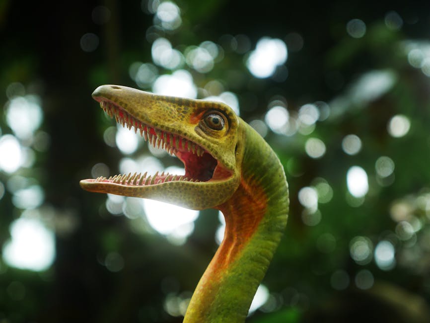 Close-up of a colorful dinosaur sculpture amidst lush greenery in Singapore.