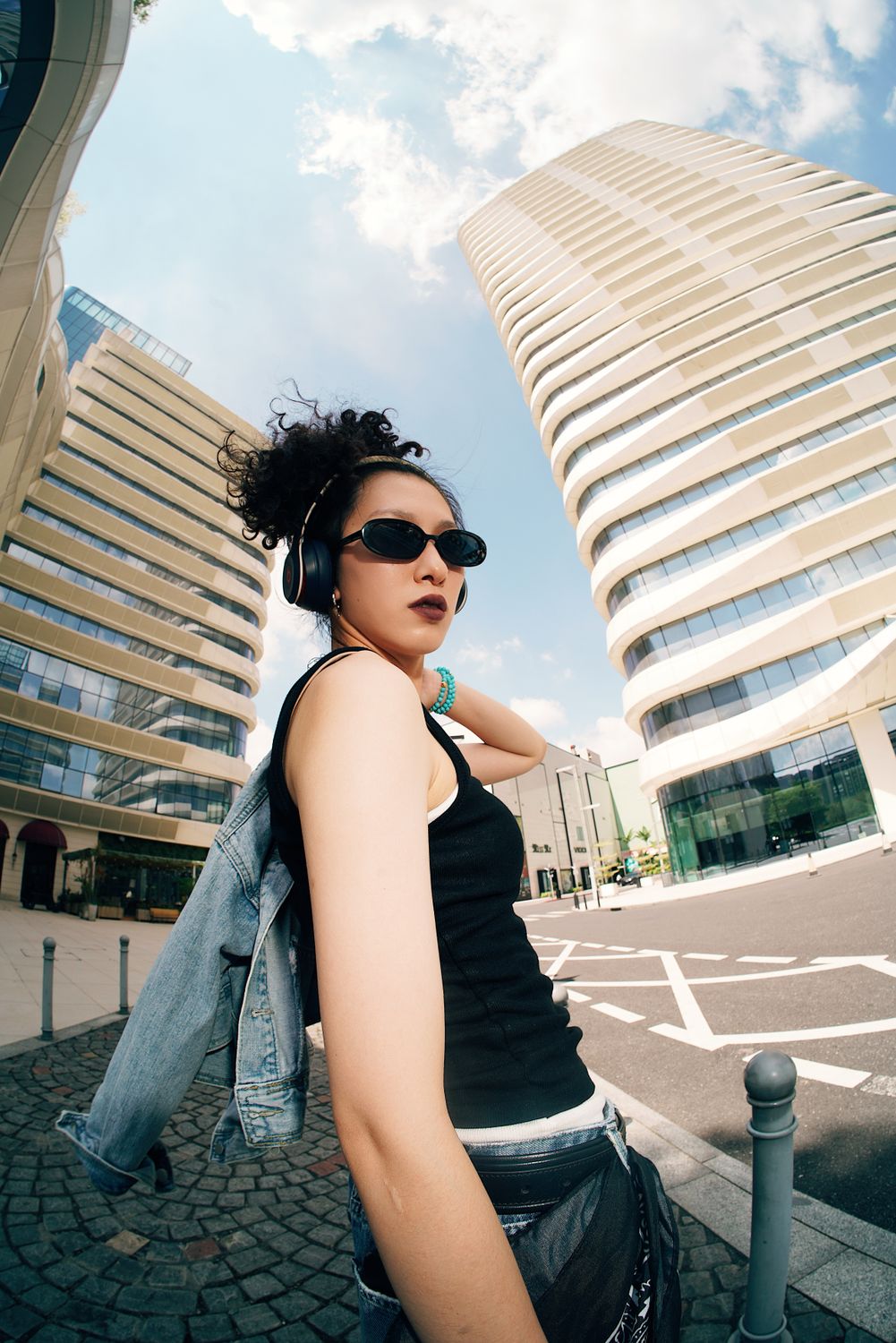 Stylish Woman in Urban Setting with Modern Architecture · Free Stock Photo