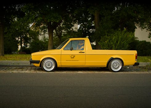 Classic yellow pickup truck parked outdoors in Berlin, Germany.
