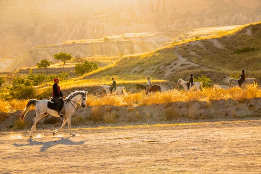 Enjoy a breathtaking horseback riding experience at sunrise amidst Cappadocia's golden hills.