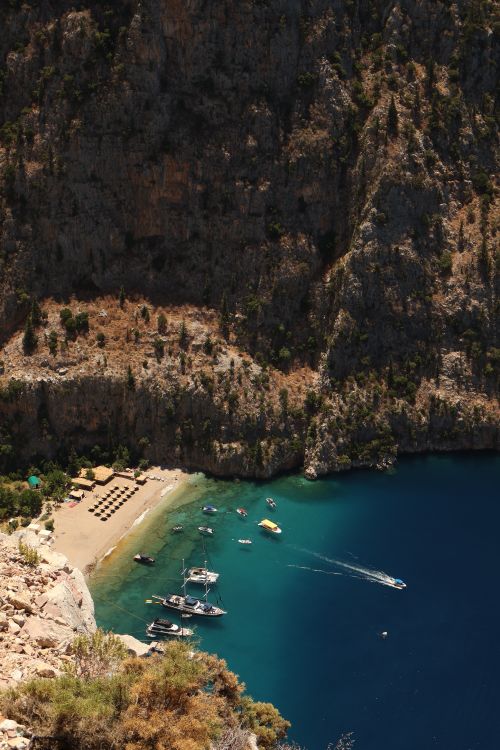 Free Discover the tranquil beauty of Butterfly Valley, a stunning beach surrounded by majestic cliffs in Muğla, Turkey. Stock Photo