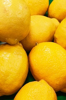 Vibrant yellow lemons clustered together, showcasing freshness and quality.