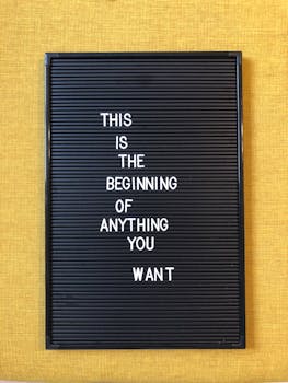Black letter board with motivational quote on yellow background.