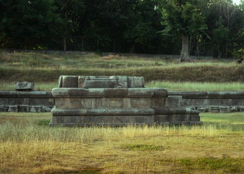 Explore these ancient ruins set in a serene grassy field, perfect for history enthusiasts.