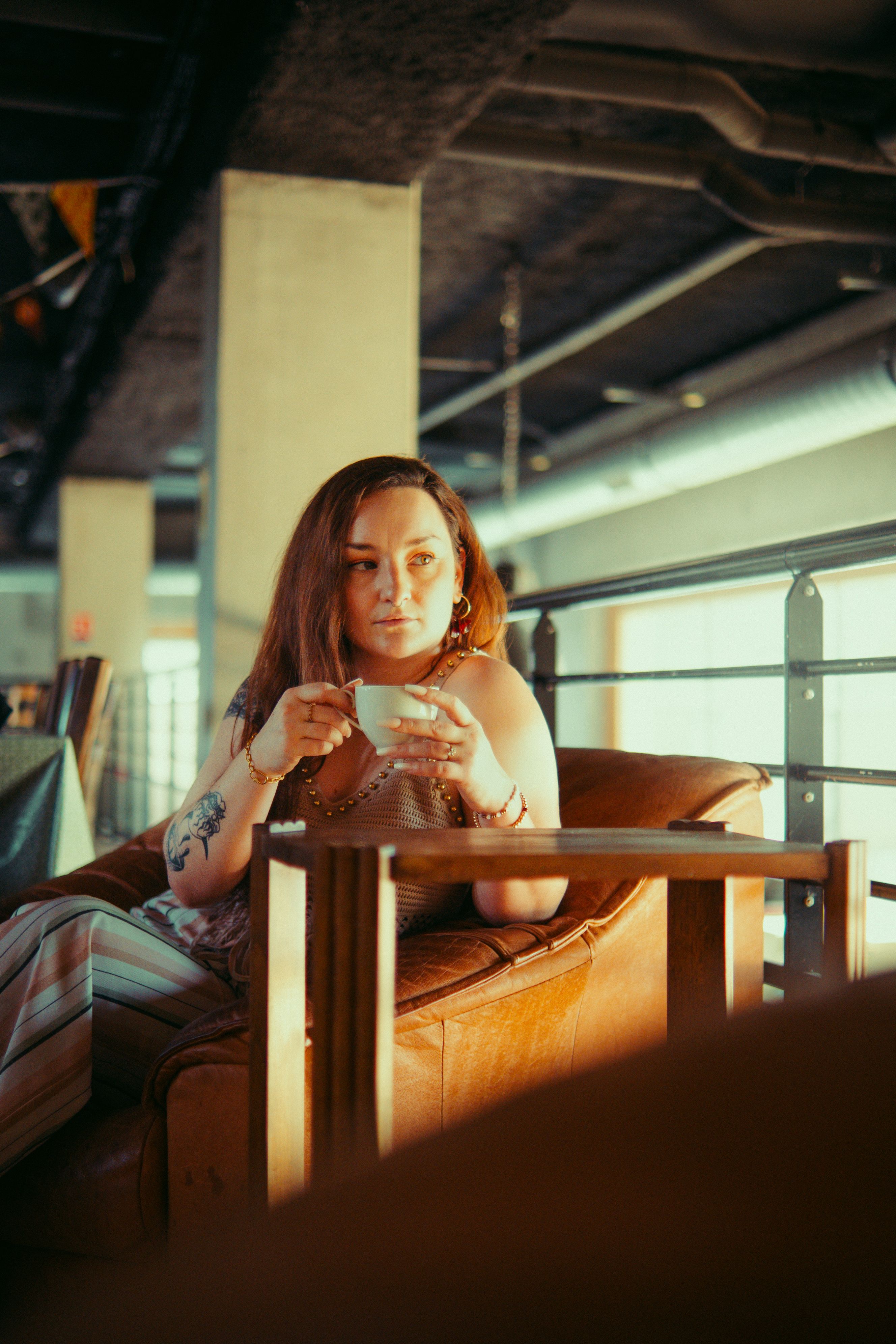 Relaxed Woman Enjoying Coffee in Modern Cafe · Free Stock Photo