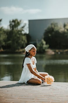 Serene portrait of a woman by the river in Lille, France, featuring a tranquil outdoor setting.