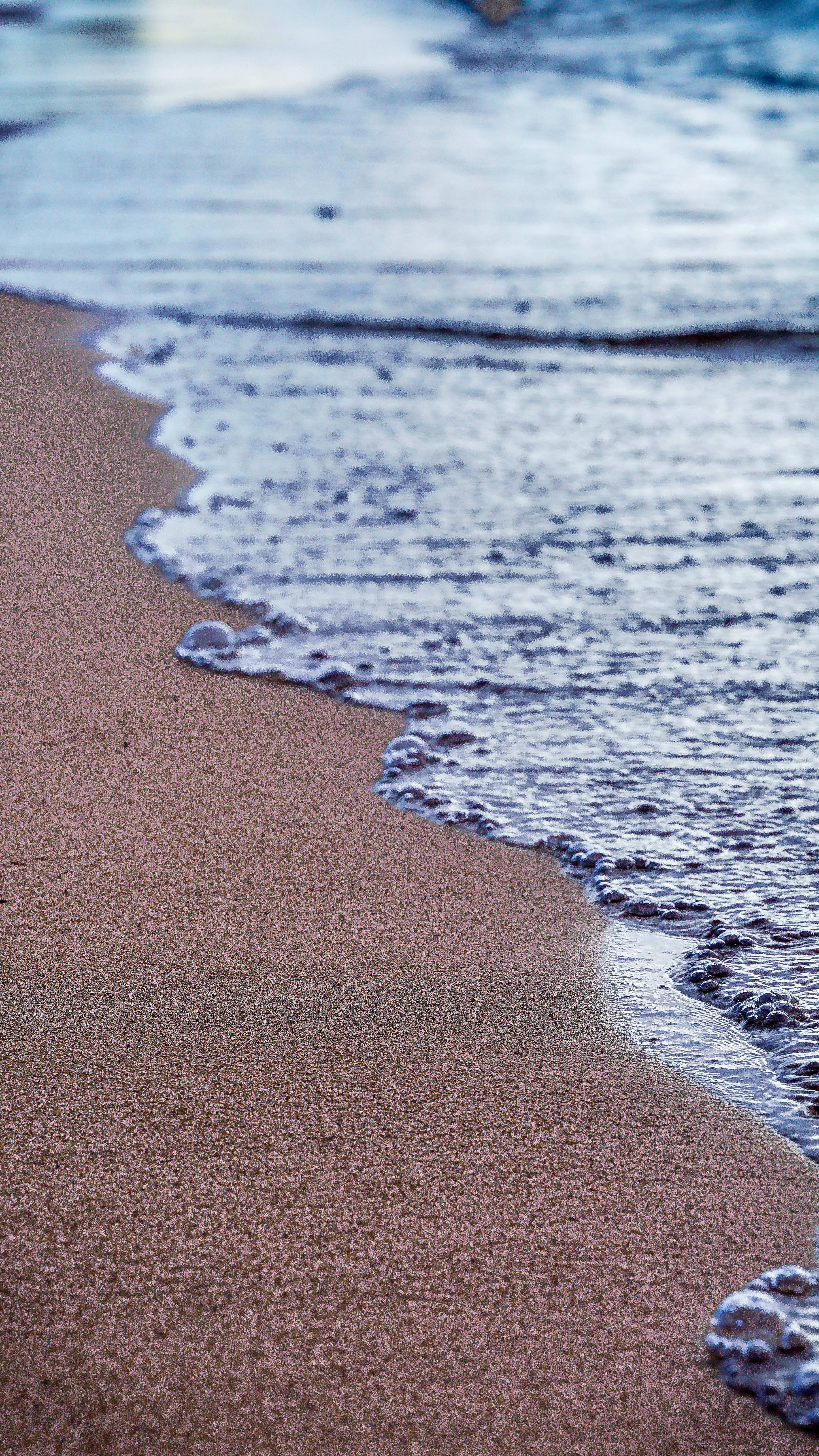 Serene Beach Shoreline at Sunrise · Free Stock Photo