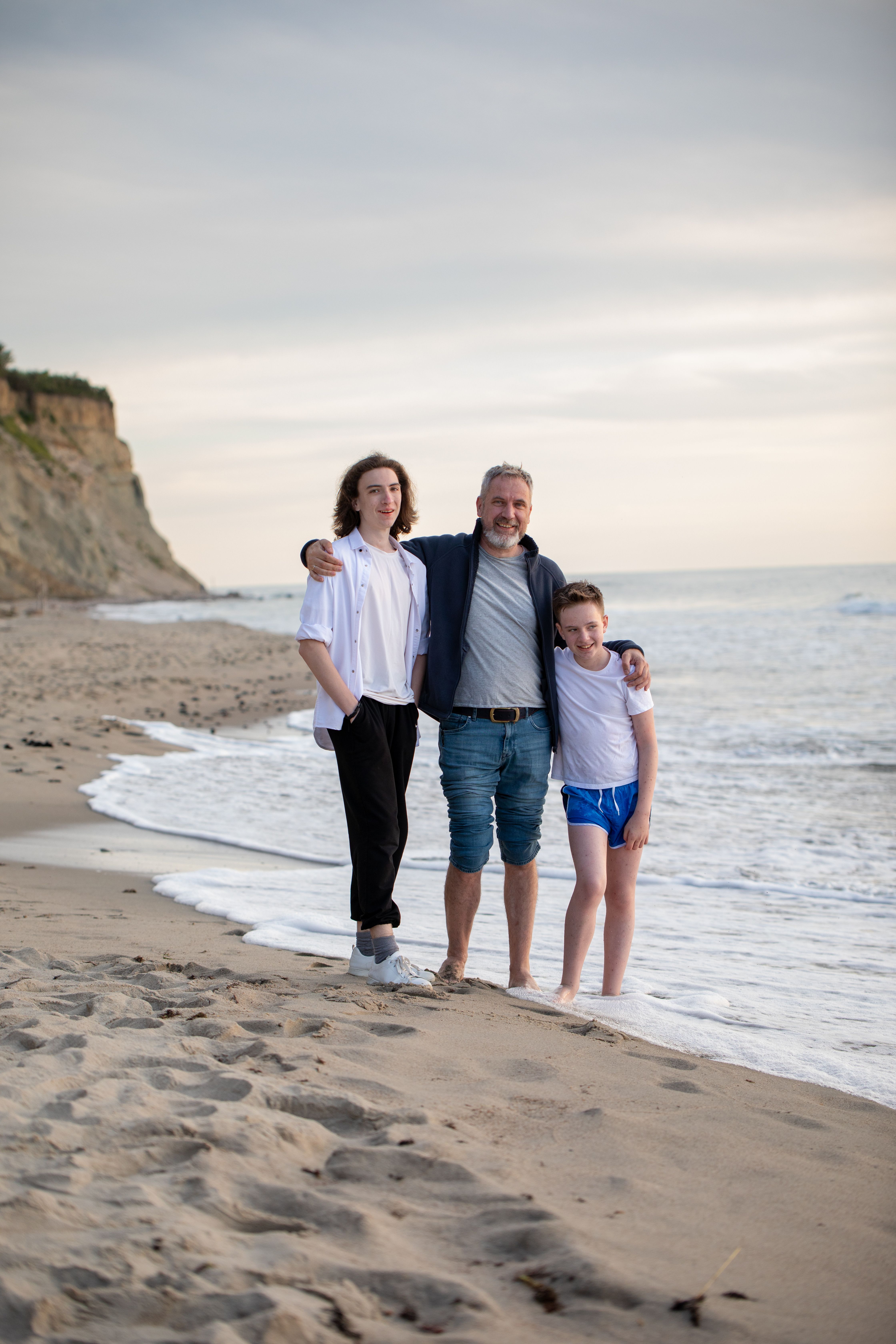 Happy Family Enjoying a Day at the Beach · Free Stock Photo