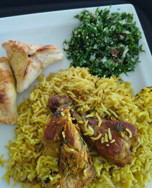 Layered Indian chicken biryani with marinated chicken, fragrant basmati rice, and fried onions, steamed together over low heat.