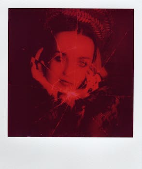 Creative portrait in a red tone with a cracked pattern effect, exuding a moody vintage feel.