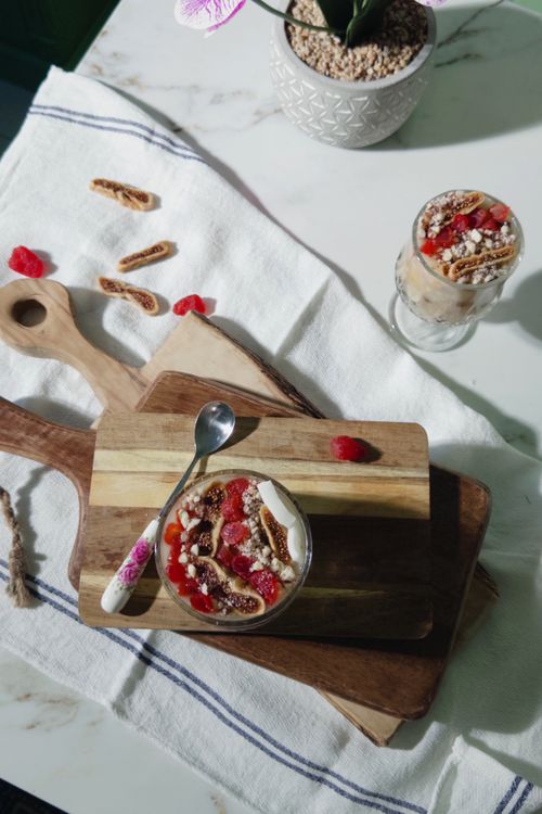 Free Top view of parfait with berries and granola on a wooden board. Stock Photo