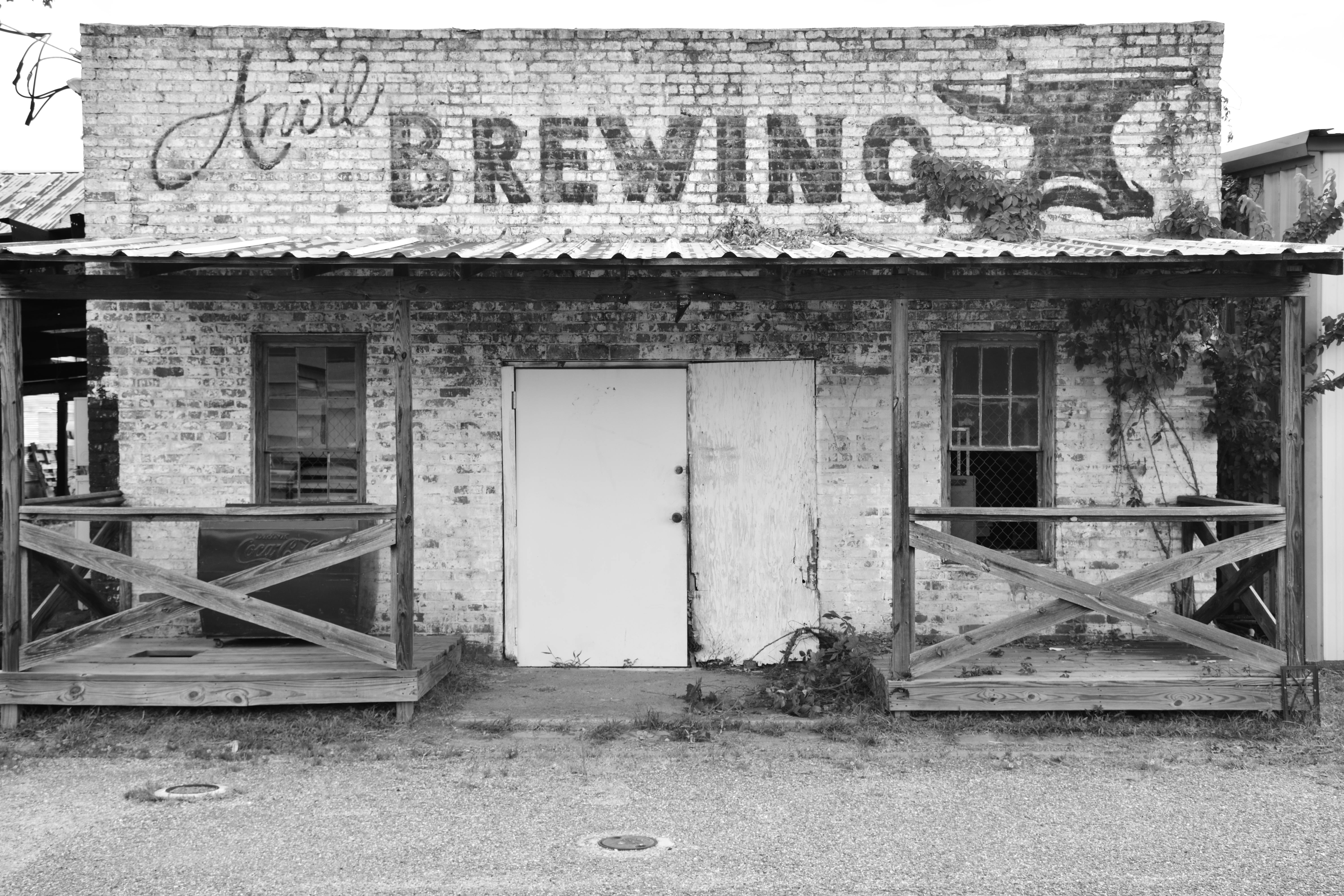 Black and white image of an early oil derrick