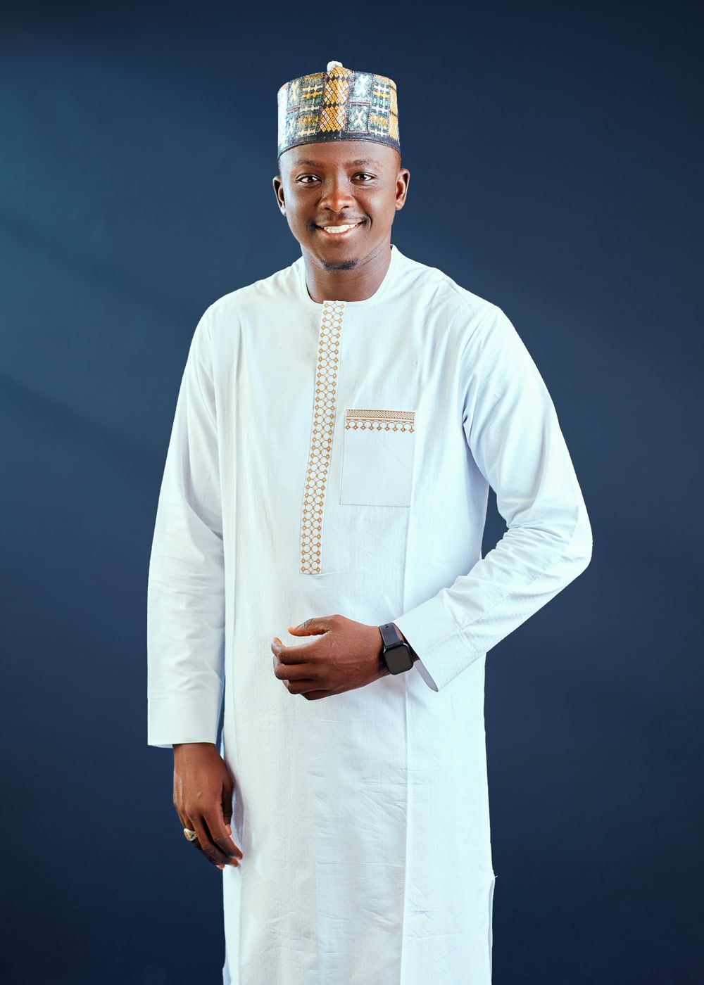 Man in traditional white outfit with an embroidered cap