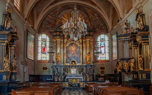 Free Beautiful ornate altar inside a historic church in Poland, showcasing stained glass windows. Stock Photo