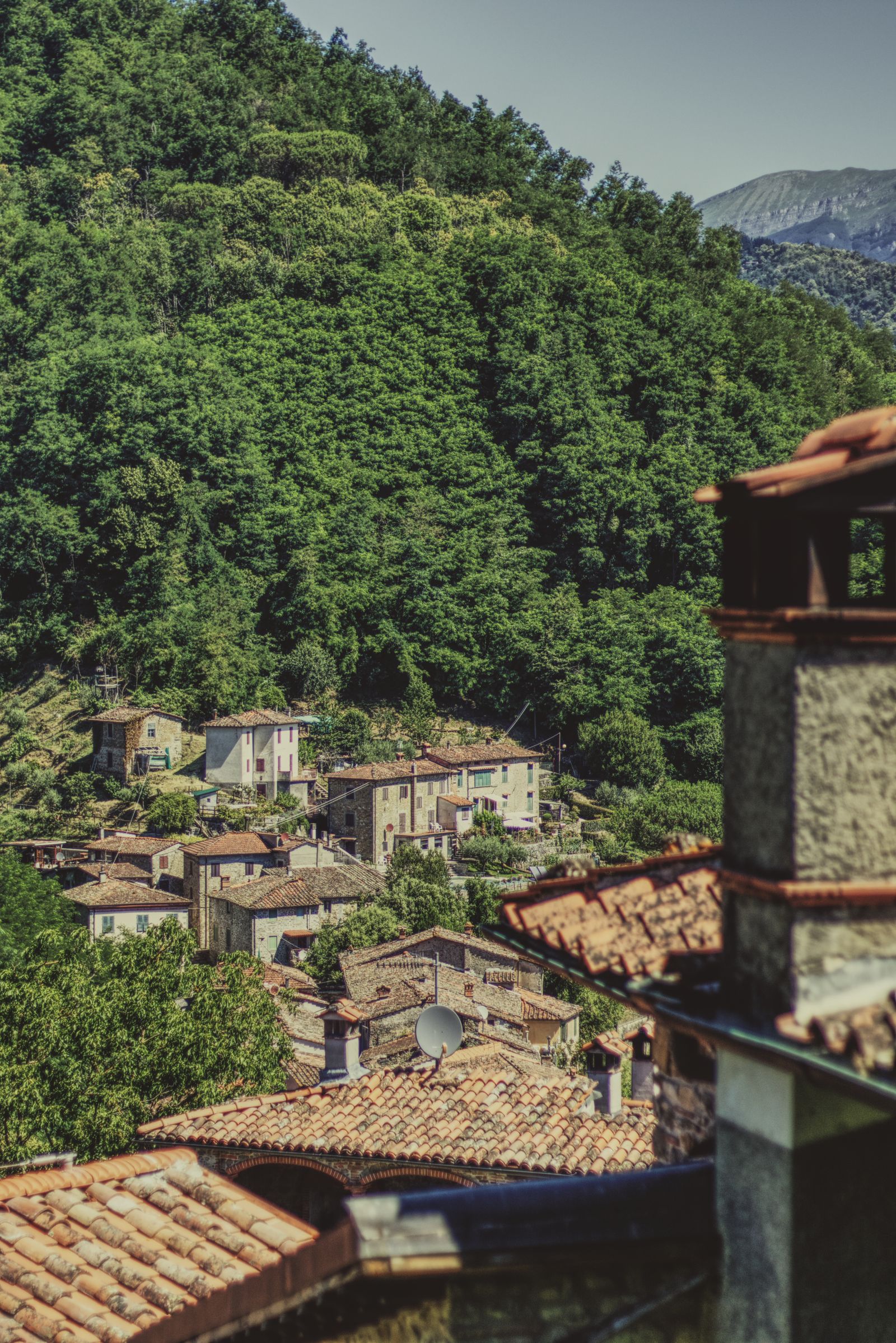 Rustic hillside village and green slopes near Lucca in northern Tuscany