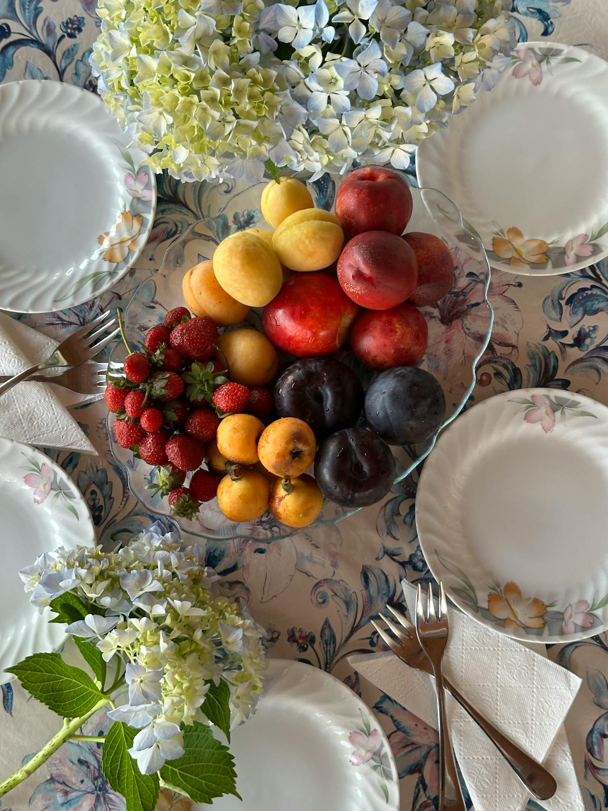 Breakfast table with coffee, croissants, and berries