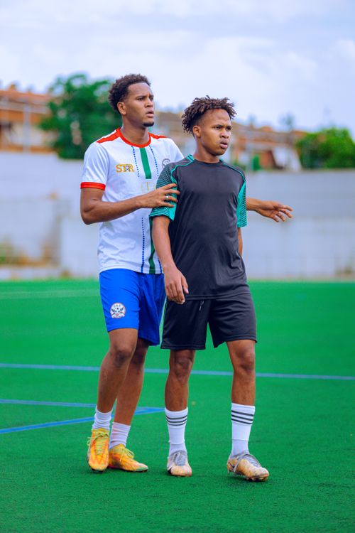 Free Two young soccer players on a field, ready to compete during the day. Stock Photo