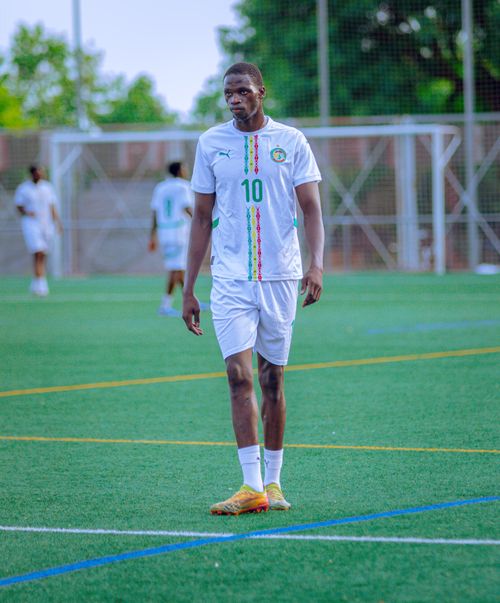 Free A soccer player in uniform on a grassy field during a day game. Stock Photo