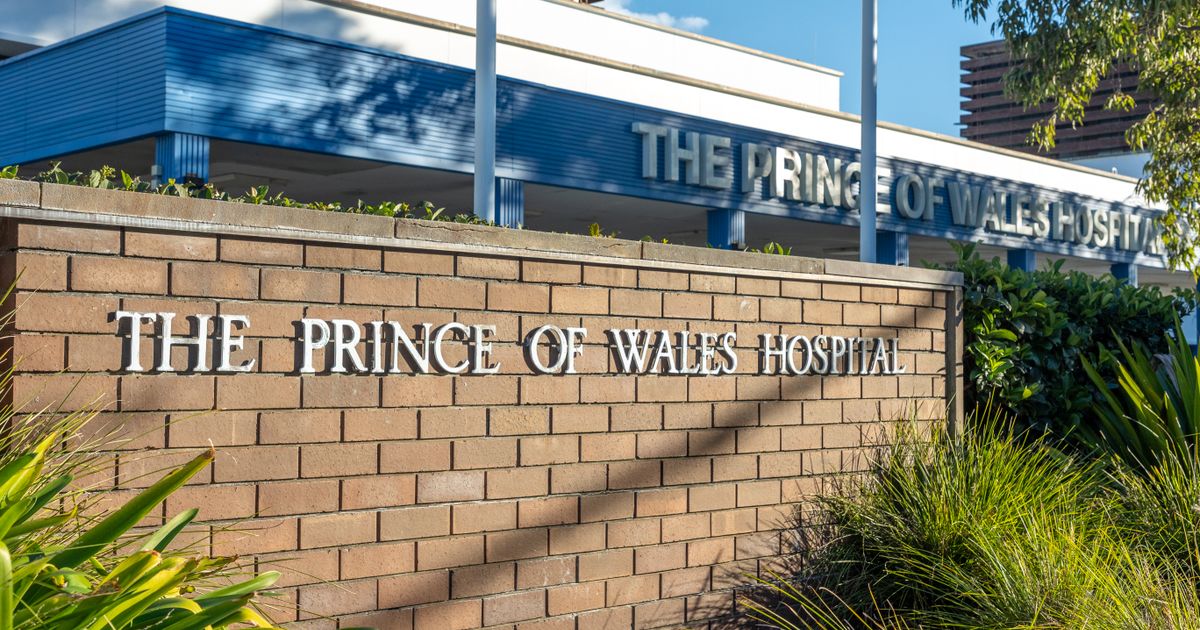 Hospital entrance with signage and greenery