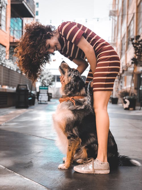 Photo Of Woman Holding Dog