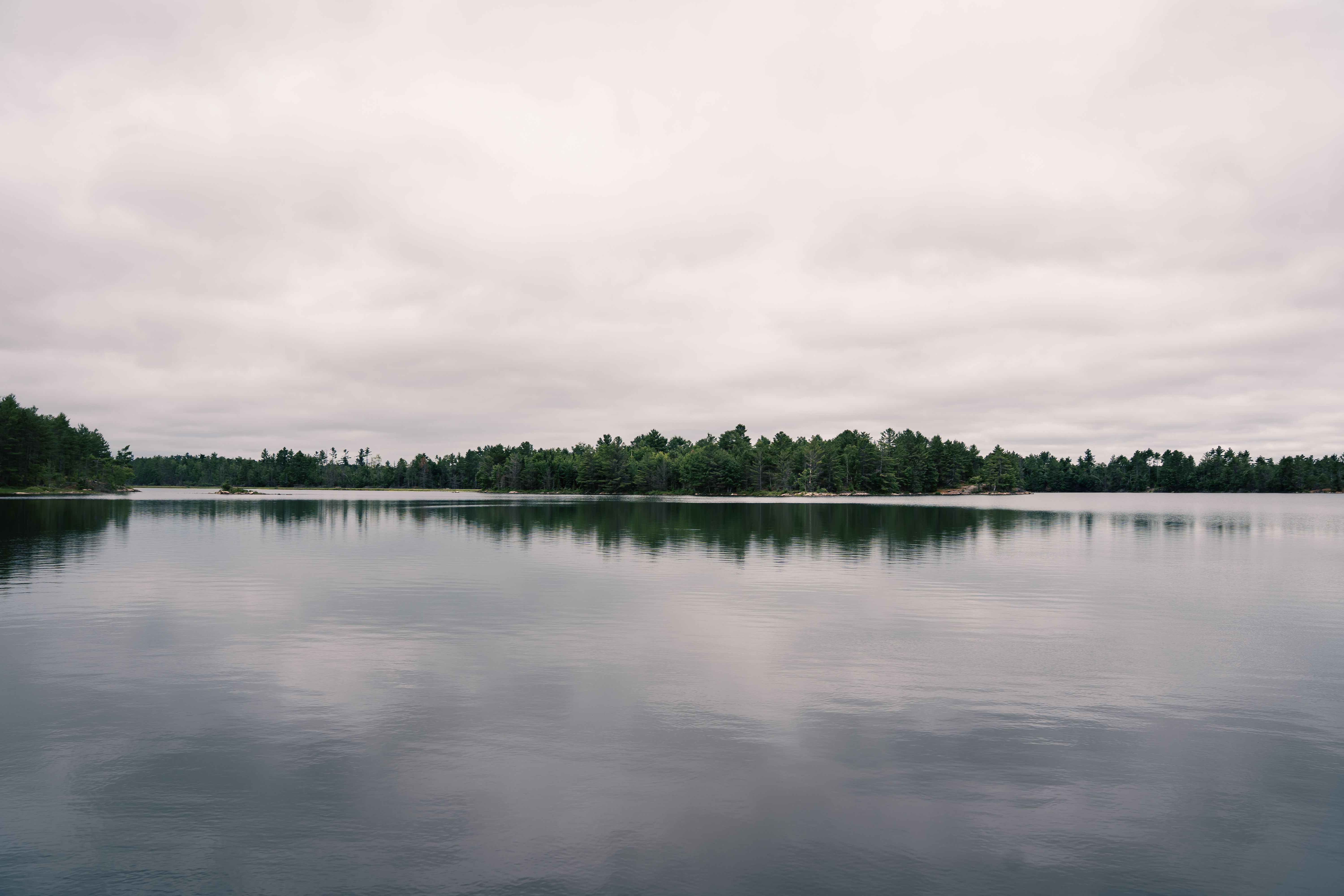 Tranquil Lake with Cloudy Sky Reflection · Free Stock Photo