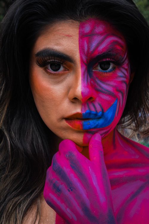Free Stunning portrait of a woman with half-face vibrant body art in Mexico City, showcasing bold and expressive makeup. Stock Photo