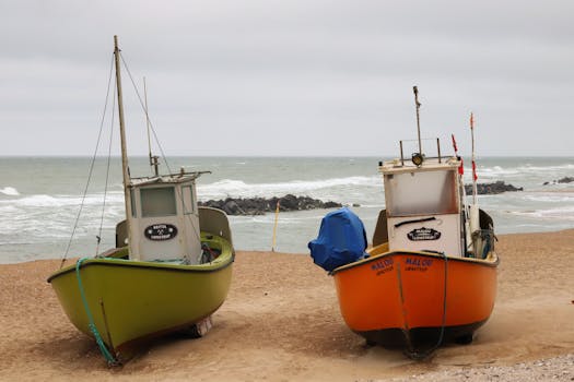 Vibrant fishing boats on a beach in Denmark near the North Sea, capturing coastal life.
