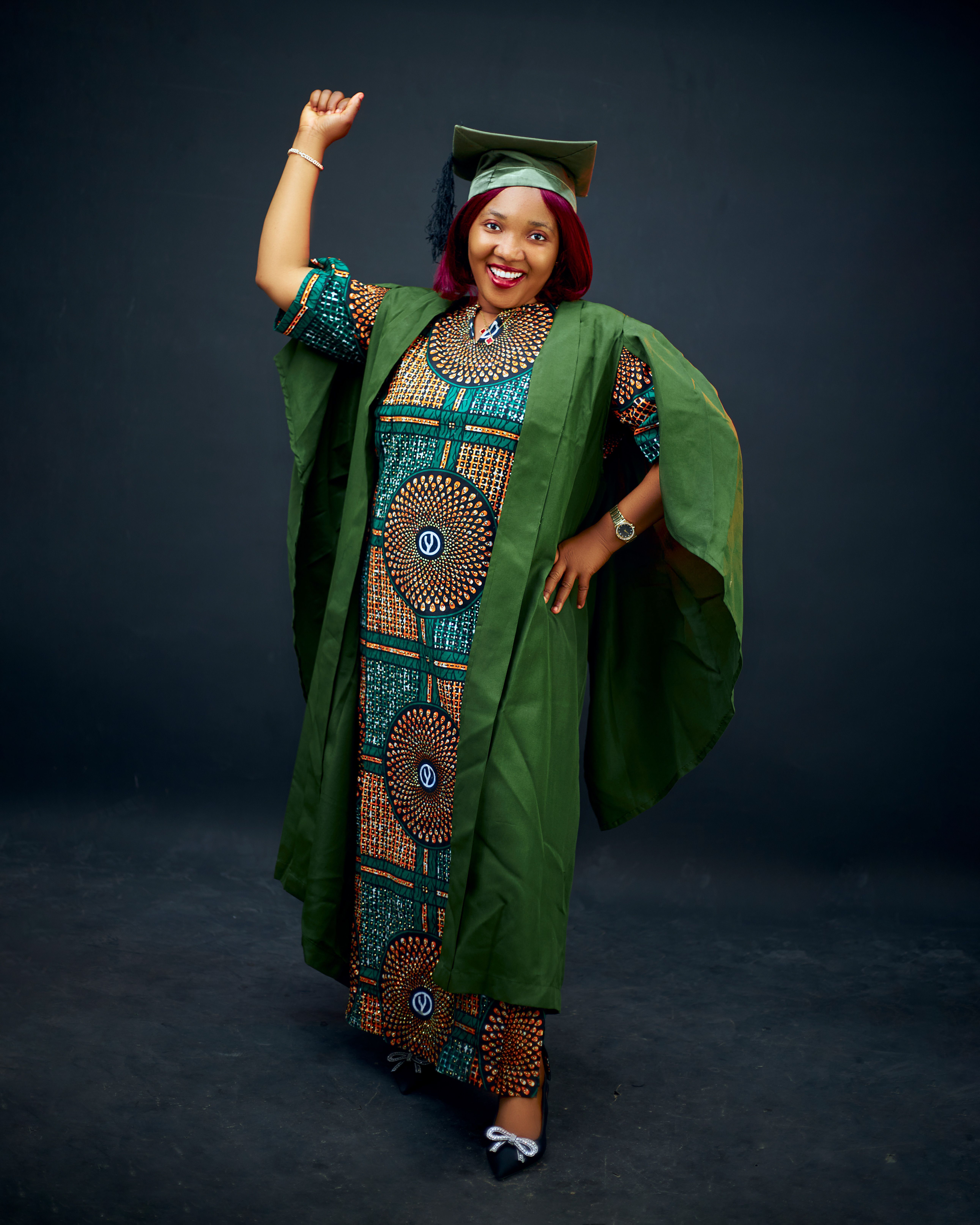 A Woman in Black Graduation Gown Holding a Rolled Paper  Free Stock Photo