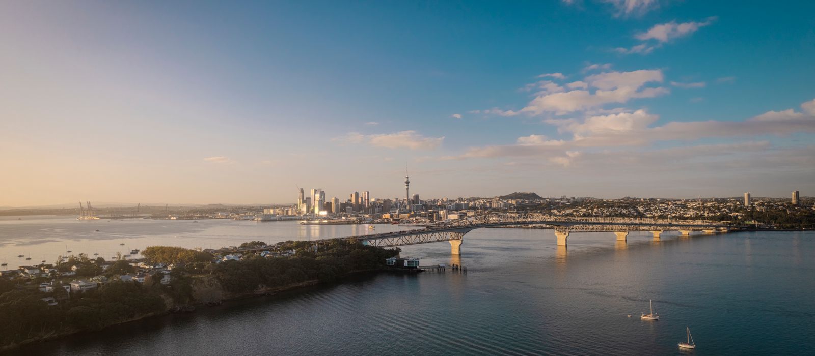 Stunning aerial view of Auckland city skyline and Harbor Bridge at sunset. — flights from Nadi to Auckland