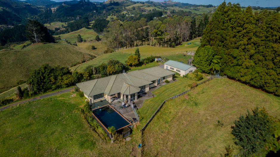 Photo by Ollie Craig on Pexels Aerial view of a modern country home with a pool nestled in the lush hills of Tauranga, New Zealand.