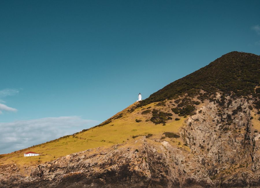 Stunning view of Cape Reinga Lighthouse on a sunny day in Northland, New Zealand.