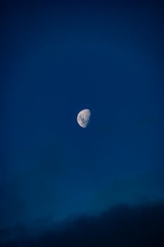 Captivating half moon in a deep blue sky captured in Northland, New Zealand.