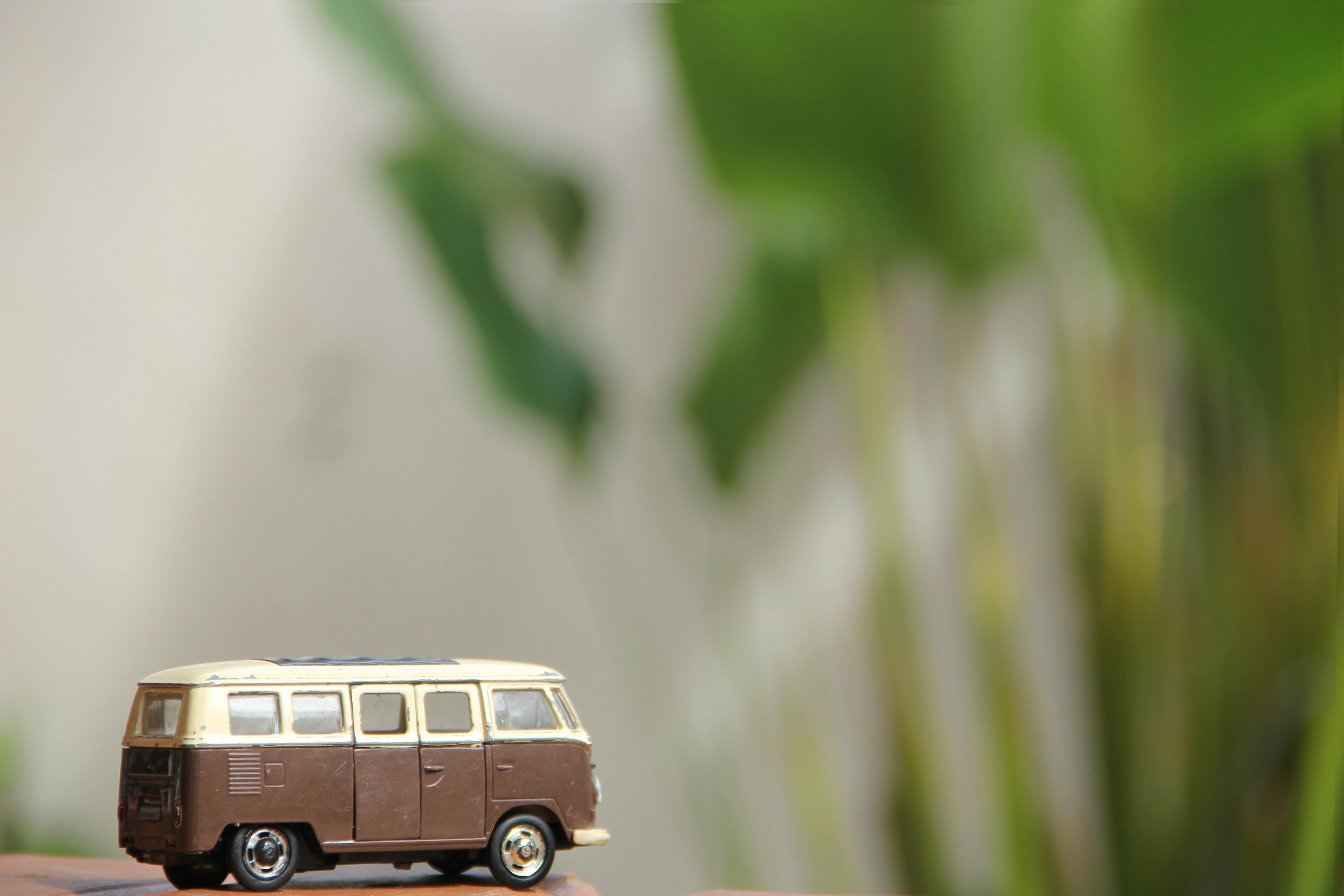 Close-up of a vintage miniature Volkswagen van model with a green bokeh background, evoking nostalgia.